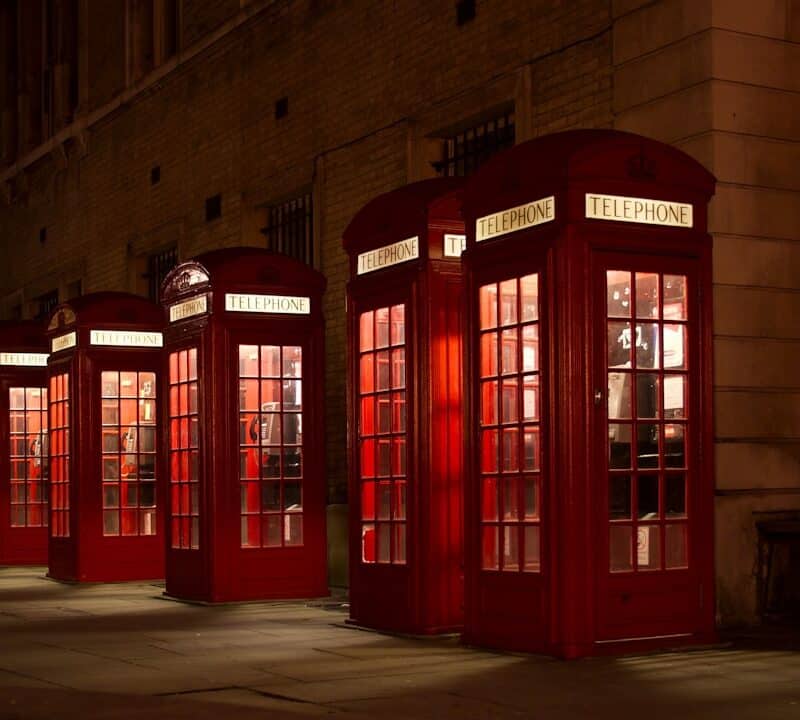 five red lined phone booths near building